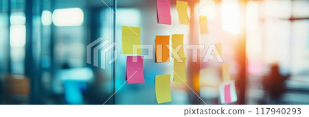 Sticky notes clipped to a glass wall in a modern office. Symbolizing business organization, planning, and team collaboration. 117940293