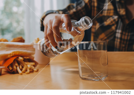 healthy beautiful young woman holding glass of water 117941002
