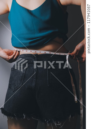 fat woman, fat belly, chubby, obese woman hand holding excessive belly fat with measure tape, woman diet lifestyle concept fat woman, fat belly, chubby, obese woman hand holding excessive belly fat with measure tape, woman diet lifestyle concept 117941087