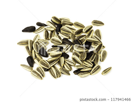 White and black sunflower seeds lying on a white background White and black sunflower seeds lying on a white background 117941466