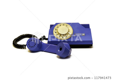 On a white background is a retro telephone with a round dialer On a white background is a retro telephone with a round dialer 117941473
