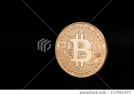 On a black background, a gold coin of Bitcoin closeup On a black background, a gold coin of Bitcoin closeup 117941475