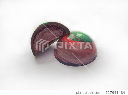 Tempered chocolate candies with a glossy painted body and fruit filling with blur elements 117941484