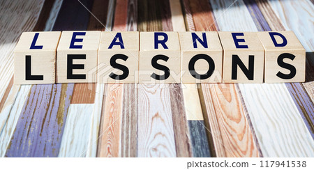 Lessons learned text on wooden blocks on a beautiful background. Business education concept. 117941538