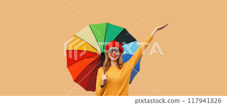 Autumn color, beautiful happy cheerful young woman holding colorful umbrella, stylish joyful girl 117941826