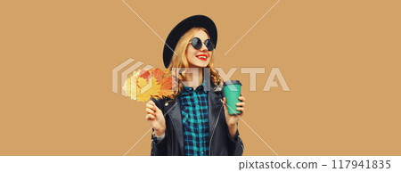 Autumn portrait of beautiful smiling young woman with yellow maple leaves, cup of coffee drink 117941835