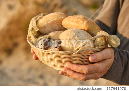 Christianity, religion, Bible concept. Five loaves of bread and two fish 117941978