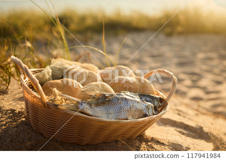 Christianity, religion, Bible concept. Five loaves of bread and two fish 117941984