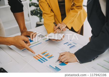 Financial analysts analyze business financial reports on a digital tablet planning investment project during a discussion at a meeting of corporate showing the results of their successful teamwork. Financial analysts analyze business financial reports on a digital tablet planning investment project during a discussion at a meeting of corporate showing the results of their successful teamwork. 117942106