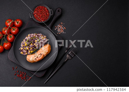 A piece of boiled salmon with rice, broccoli, salt and spices 117942384