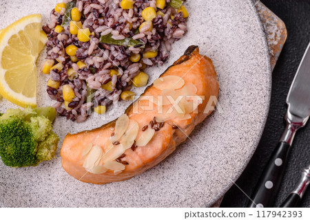 A piece of boiled salmon with rice, broccoli, salt and spices 117942393