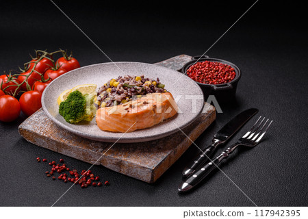 A piece of boiled salmon with rice, broccoli, salt and spices 117942395