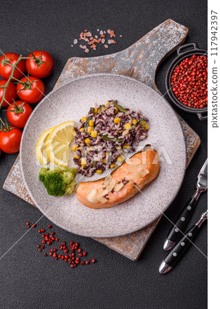 A piece of boiled salmon with rice, broccoli, salt and spices 117942397