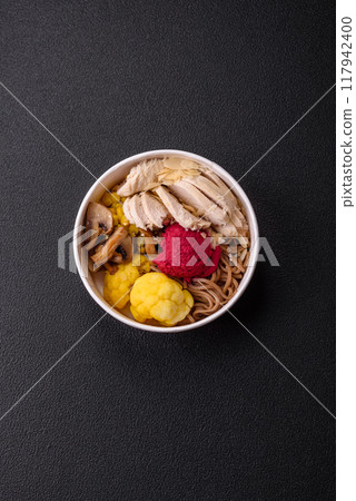 Asian dish with sliced chicken fillet, buckwheat noodles, soy sauce 117942400