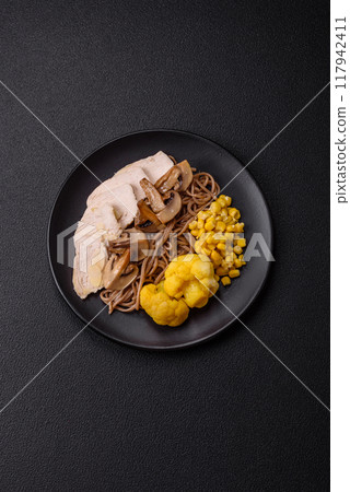 Asian dish with sliced chicken fillet, buckwheat noodles, soy sauce Asian dish with sliced chicken fillet, buckwheat noodles, soy sauce 117942411