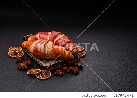 Delicious fresh crispy croissants with chocolate filling 117942471