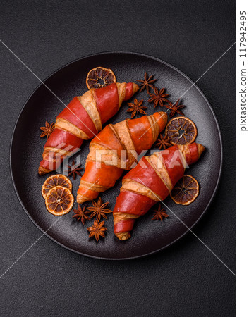 Delicious fresh crispy croissants with chocolate filling 117942495