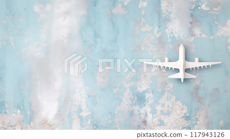 Airplane model on a blue concrete background. Copy space. 117943126