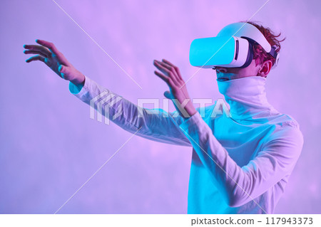 Person wearing virtual reality headset, seemingly engaging with digital environment. Background features soft gradient colors, highlighting immersive experience 117943373