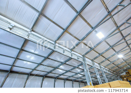 Metal frame for new barn is currently underway with steel constructions Metal frame for new barn is currently underway with steel constructions 117943714