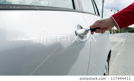 Man Opening The Car's door With The Keys  117944411
