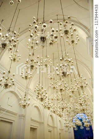 Blank porch with barrel arches and hanging chandeliers 117944438