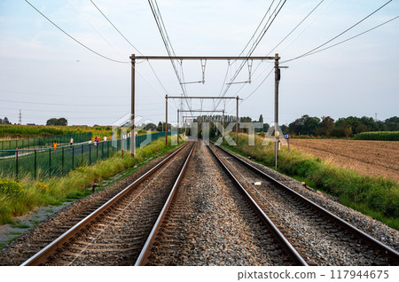 Asse, Flemish Brabant, Belgium - Aug 31, 2024 - Perspective view over double railwaytrack 60 to Dendermonde 117944675