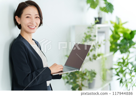 Business woman using a personal computer Business woman using a personal computer 117944886