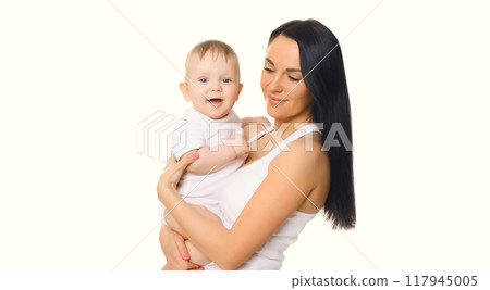 Happy cheerful smiling mother holding baby, joyful young mom and little child on white background 117945005