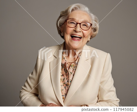 Elderly woman in blue sweater and glasses happily laughing Elderly woman in blue sweater and glasses happily laughing 117945082
