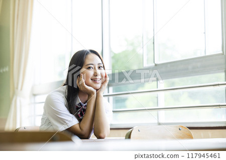 High school girl sitting on a chair in the classroom High school girl sitting on a chair in the classroom 117945461