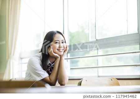 High school girl sitting on a chair in the classroom 117945462