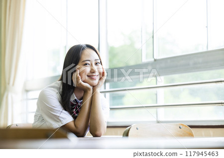 High school girl sitting on a chair in the classroom High school girl sitting on a chair in the classroom 117945463