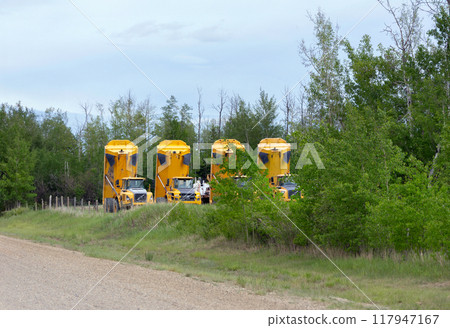 Articulated haulers parked at the rental yard at the road. 117947167