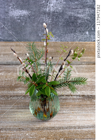 Nature's Easter bouquet with pussywillow and evergreen plants on the table. 117947282