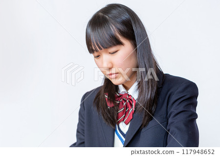 Close-up of a schoolgirl sitting at her desk 117948652