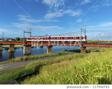 A Kintetsu Myoji Line train crossing the Yamato River in midsummer A Kintetsu Myoji Line train crossing the Yamato River in midsummer 117948783