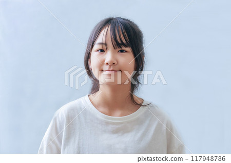 A girl smiling at the camera A girl smiling at the camera 117948786