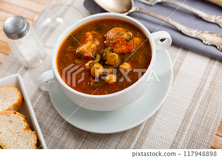 Cocido Andaluz - Spanish dish, thick and hearty stew made with meat, lard, sausages, legumes and vegetables, cooked over low heat Cocido Andaluz - Spanish dish, thick and hearty stew made with meat, lard, sausages, legumes and vegetables, cooked over low heat 117948898