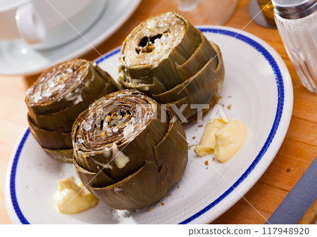 Steamed artichokes with sauce aioli 117948920