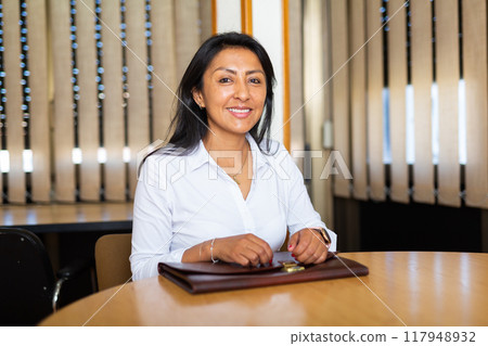Latino american woman waiting for job interview Latino american woman waiting for job interview 117948932