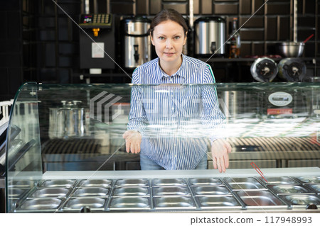 Friendly saleswoman offering bubble tea at street stall 117948993