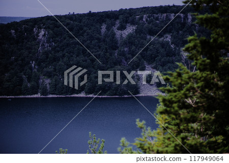 Bluff overlooking lake tree foreground 117949064