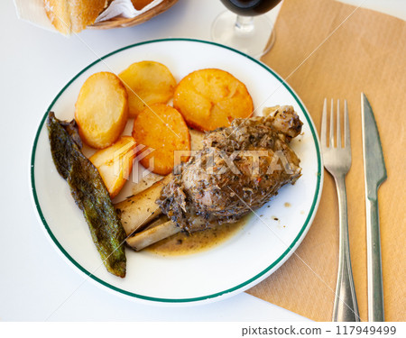 Braised pork knuckle with fried potatoes and baked pepper Braised pork knuckle with fried potatoes and baked pepper 117949499
