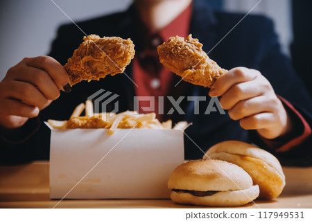 close up focus woman hand hold fried chicken for eat,girl with fast food concept 117949531