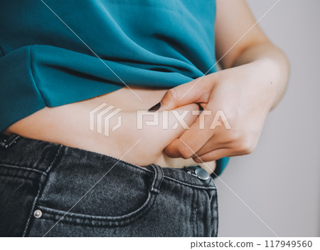 fat woman, fat belly, chubby, obese woman hand holding excessive belly fat with measure tape, woman diet lifestyle concept fat woman, fat belly, chubby, obese woman hand holding excessive belly fat with measure tape, woman diet lifestyle concept 117949560