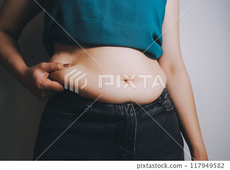 fat woman, fat belly, chubby, obese woman hand holding excessive belly fat with measure tape, woman diet lifestyle concept fat woman, fat belly, chubby, obese woman hand holding excessive belly fat with measure tape, woman diet lifestyle concept 117949582