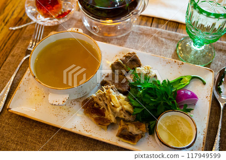 Young bull meat in its own juice with herbs. Khashlama 117949599