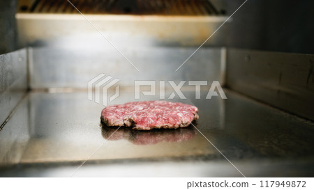 Slow Flipping Of The Burger Meat Cooking  117949872