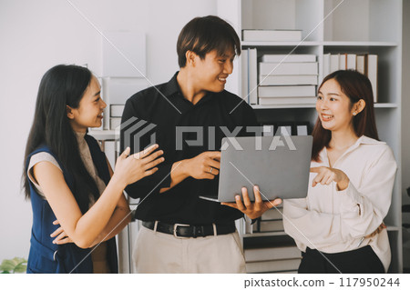 Financial analysts analyze business financial reports on a digital tablet planning investment project during a discussion at a meeting of corporate showing the results of their successful teamwork. 117950244
